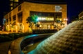 Fountain and the John Hopkins Carey Business School at night in