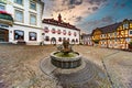 Fountain made of copper in the middle of the old marketplace with half-timbered houses and the town hall in the background in Linz