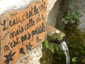 Fountain with message in Saint-guilhem-le-desert, a village in herault, languedoc, france Royalty Free Stock Photo