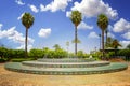 Fountain near Koutoubia Mosque minaret at medina quarter of Marrakesh, Morocco. There is beautiful green garden with palms. Blue Royalty Free Stock Photo