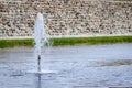 The Fountain near medieval castle wall Royalty Free Stock Photo