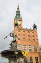 Fountain of the Neptune with Town Hall with clock in the background, Old City, Gdansk, Poland Royalty Free Stock Photo