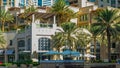 Fountain and palms timelapse at the Marina walk, During day time. Dubai, UAE