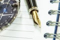 Fountain pen on blank notepad and watch Royalty Free Stock Photo