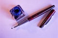 Fountain pen, blue ink and inkwell on white paper sheet Royalty Free Stock Photo