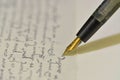 Fountain pen on a blurred letter background. Old fountain pen on an vintage handwritten letter. Conceptual background on