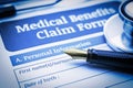 Fountain pen, a chest-piece of a stethoscope and a medical benefits claim form on a clipboard. Royalty Free Stock Photo