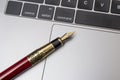 Fountain pen closeup on laptop pad agreement concept Royalty Free Stock Photo