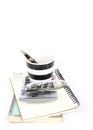 Fountain pen in coffee cup and calculator on books stack Royalty Free Stock Photo