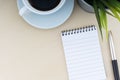 Fountain pen, decorative plant, notepad and cup of coffee on wooden background Royalty Free Stock Photo