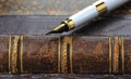 Fountain pen with a gold pen lying on old book Royalty Free Stock Photo