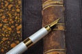 Fountain pen with a gold pen lying on old book Royalty Free Stock Photo