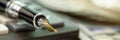 Fountain pen golden quill put on calculator edge macro Royalty Free Stock Photo