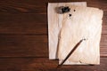 Fountain pen, inkwell and vintage parchment with ink stains on wooden table, flat lay. Space for text Royalty Free Stock Photo