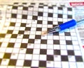 A fountain pen lies on a newspaper with a crossword puzzle Royalty Free Stock Photo