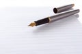 Fountain pen lying on page in a spiral bound notep Royalty Free Stock Photo