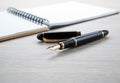 Fountain pen near the notepad on the desktop Royalty Free Stock Photo