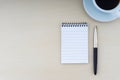 Fountain pen, notepad and cup of coffee on wooden background Royalty Free Stock Photo