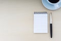 Fountain pen, notepad and cup of coffee on wooden background Royalty Free Stock Photo