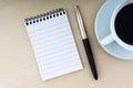 Fountain pen, notepad and cup of coffee on wooden background Royalty Free Stock Photo