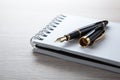 Fountain pen on the notepad on the desktop Royalty Free Stock Photo