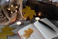 Fountain pen on old handwritten book with autumn leaves on a lacy tablecloth