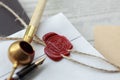 Fountain pen and old notarial wax seal on document, closeup