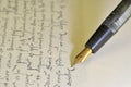 Fountain pen on paper with ink text on vintage handwriting. Close-up. Fountain pen on an antique handwritten letter Royalty Free Stock Photo