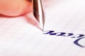 Fountain pen writing on squared notebook Royalty Free Stock Photo