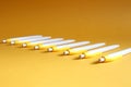 Fountain pens lie in a row on a yellow background, side view, space for text Royalty Free Stock Photo