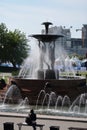 Fountain-people hold a large stone bowl from which water jets beat