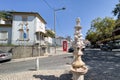 A fountain with Red telephone booth in the background on the sidewalk in Sintra