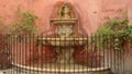 Fountain on rouge wall in Seville Royalty Free Stock Photo