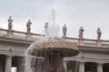 Fountain of Saint Peters Square playing infront saints statues standing on peters basilica colonnade Royalty Free Stock Photo