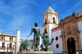 Fountain showing Hercules taming lions with the Socorro Parish church to the rear in the Plaza del Socorro, Ronda, Spain.