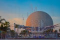 Fountain and Spaceship Earth attraction in Epcot on light blue sky background at Walt Disney World .