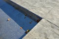 Fountain in the square lined with a mosaic of tiles. through a science terrace or bridge made of metal stainless steel slats. the Royalty Free Stock Photo