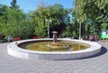 The fountain in the Strukovsky garden with the established bronze sculpture of the boy and girl under an umbrella in the sunny day Royalty Free Stock Photo