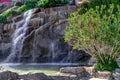 Fountain stylized as a waterfall from a cliff on the embankment of  Alanya Marina Yat Limani Turkey. Water streams falling from Royalty Free Stock Photo