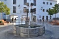 Fountain in the town Hall Square which is a wrought iron pillar with four taps and their respective cups