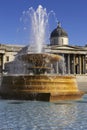 Fountain in Trafalgar square with national portrait gallery in the background