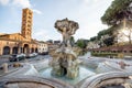 Fountain of the Tritons and Church of Santa Maria in Cosmedin in Rome Royalty Free Stock Photo