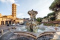 Fountain of the Tritons and Church of Santa Maria in Cosmedin in Rome Royalty Free Stock Photo