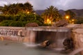 Fountain in an urban park at sunset. Royalty Free Stock Photo