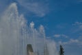 Fountain water jets on a background of blue summer sky close-up. Royalty Free Stock Photo