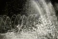 Fountain water jets in park partially blurred bokeh Royalty Free Stock Photo