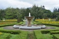 Fountain water in the public park full of colorful flowers