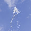 Fountain water splash against blurred sky with clouds, selective focus, shallow DOF Royalty Free Stock Photo