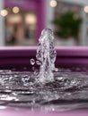 Fountain water splash with ripples in pink setting. Royalty Free Stock Photo