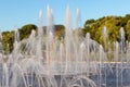 Fountain with water spurting up different streams. Multi-colored rainbow in the fountain. Royalty Free Stock Photo